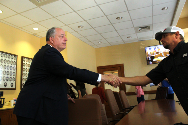 Senior Director of Infrastructure Bob Daigh, left, shakes hands with a Jonah resident Mark Sheperd after answering his and other’s questions regarding the bridge on Tuesday morning. Photo by Nalani Nuylan