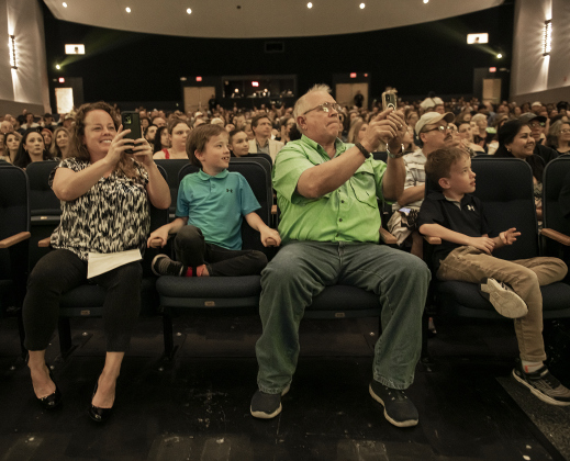 Lindsey Lauder, left, her father, Tracy Wiggers, second from right, are joined by Lindsey's twin 9-year-old sons John Cunningham, left, and David Cunningham, right, as they watch Lindsey's daughter Grace Cunningham receive her diploma during the 2024 Richarte High School Commencement.