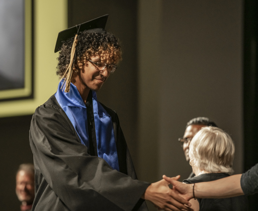 Eliezer Montero is congratulated after receiving his diploma during the 2024 Richarte High School Commencement.