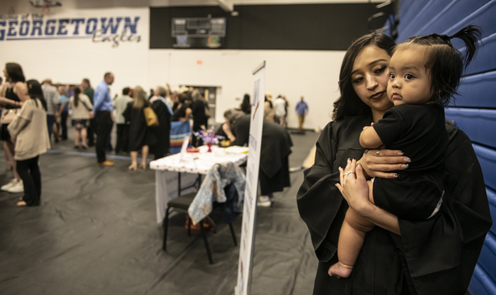 Nadia Ortegon holds her 9-month-old daughter Rae'Lynn Cadena after Nadia received her diploma during  the 2024 Richarte High School Commencement .