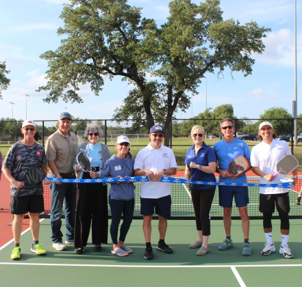Representatives celebrate the opening of new pickleball courts at Southwest Williamson County Regional Park in Leander.  Cutting the ribbon are, from left, Steve Loranger from USA Pickleball, Williamson County Parks Director Russell Fishbeck, Commissioner Terry Cook, Jo Tramell from USA Pickleball, George Olivencia from USA Pickleball, Commissioner Valerie Covey, Walter Sotillo from Round Rock Pickleball and Izaak Gonzalez from HUDEF Pickleball Pro Team. Photo courtesy of Williamson County.
