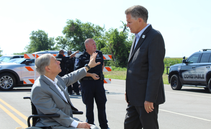 Governor Greg Abbott and County Judge Bill Gravell talk about the development in Taylor before the event.