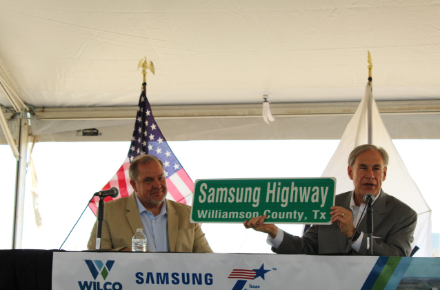 County Commissioner Russ Boles presents a “Samsung Highway” street sign to Governor Greg Abbott to hang in his office.