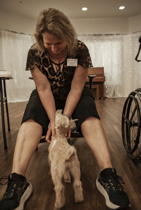 Melissa Meiske, the center's Activities Director, brings Bo to work with her  every day.  He's  up to 7 pounds now, but will likely get no larger than 15-20 pounds when grown.   Meiske bottle-feeds Bo three times a day.  While at the center, Bo wears a diaper because he's still potty training.