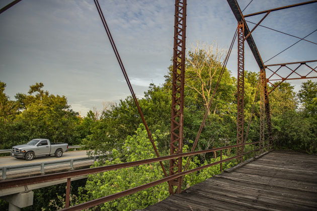 A truck passes the the long-retired truss bridge along County Road 366 in the Rowe Valley area on Tuesday, June 11, 2024.