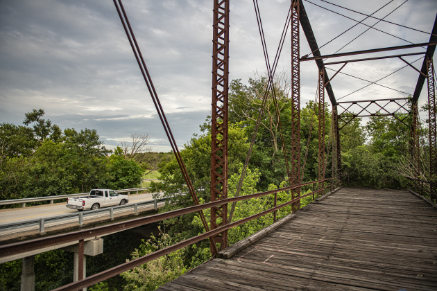 A truck goes past the long-retired truss bridge along County Road 366 in the Rowe Valley area on Tuesday, June 11, 2024.