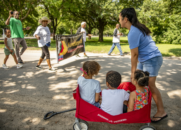 Aaliyah King, 6, left, is joined by her brother Isaiah, 4, and sister Laylah, 3, as they and their mother Lisa King watch participants take part in a parade through San Gabriel Park during the Georgetown Cultural Citizen Memorial Association's 72nd Annual Juneteenth Celebration on Saturday, June 15, 2024.  The event took place at the San Gabriel Community Center.   Juneteenth commemorates June 19, 1865, when former slaves found out they were freed.    Photo by Andy Sharp. 