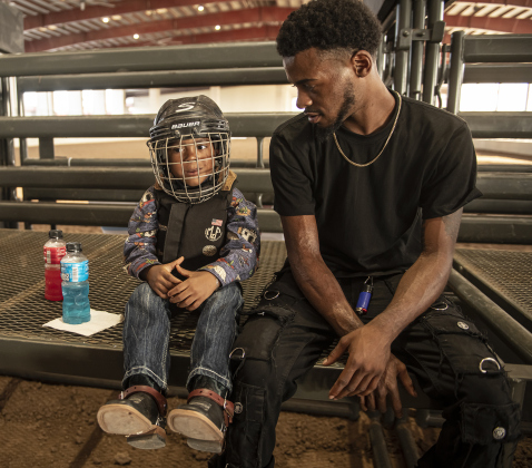 4-year-old Marcus Newman II relaxes with his father Marcus Newman as he gets ready to to compete in Mutton Bustin' at the 1st Annual Bill Pickett Youth Rodeo, held at the Williamson County Expo Center  on Saturday, June 15, 2024.   The rodeo was open to entrants 18-years-old or younger.    Photo by Andy Sharp.
