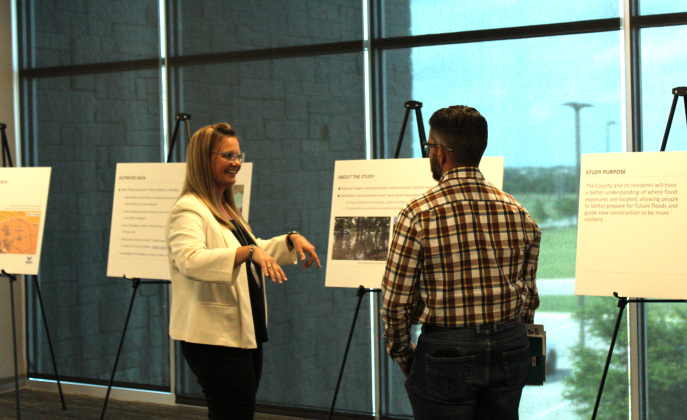 Cindy Engelhardt, left, explains how the Atlas 14 maps show rainfall data to Jarrell City Engineer Jorge L. Hernandez. Photos by Nalani Nuylan.