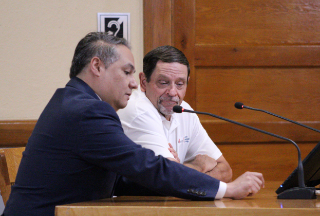  President of the World Trade Council of Central Texas Ben Ramirez, front, accompanied by Dave Porter from the Williamson County Economic Development Corporation Partnership explains the Memorandum of Understanding of a Sister City Agreement during the July 2 Commissioners Court meeting. Photo by Nalani Nuylan.