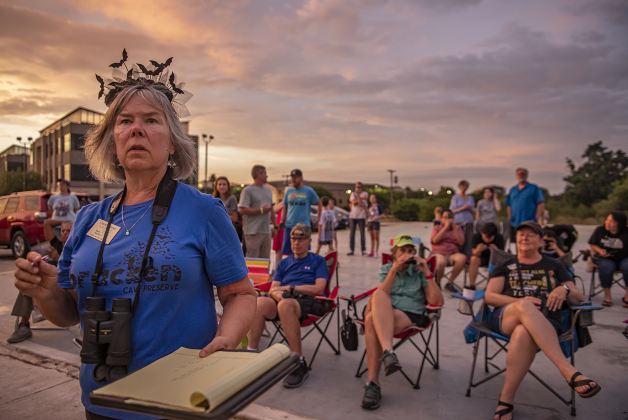 Texas Master Naturalist Christie Gardner joins others on the lookout for Mexican Free-tailed bats gathering around the McNeil Street bridge along Interstate 35 in Round Rock  on Saturday, July 13, 2024.