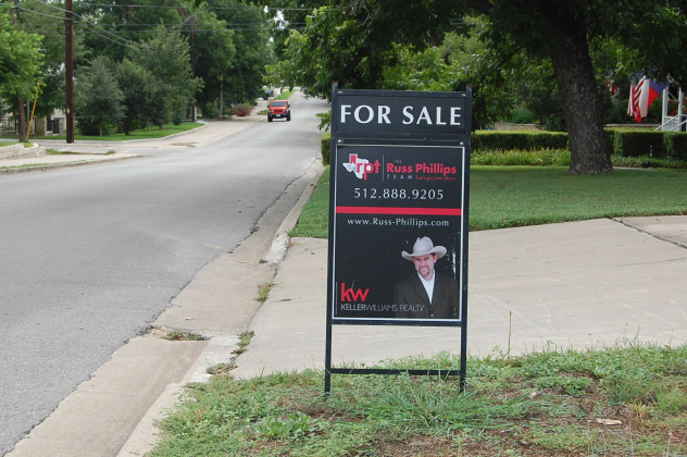 A house on East Seventh Street features a for sale sign in the yard. (Photo by Kaitlyn Wilkes)