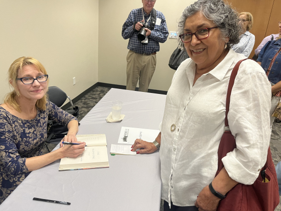 Elizabeth Crook signing Norma Gaines’ copy of The Madstone.