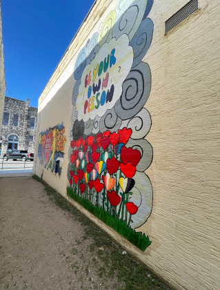 Two student murals are seen in on the Tejas Meat Supply building.
