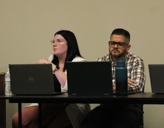 Jarrell’s Director of Planning and Development Jordan Cantu, left, is joined by City Engineer Jorge Hernandez, right, to discuss agenda items during the July 2 city council meeting. Photo by Nalani Nuylan.