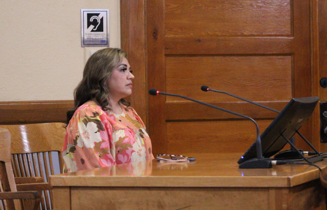 Williamson County Elections Administrator Bridgette Escobedo answers the Commissioner's questions about the pre-numbered ballots. Photo by Nalani Nuylan.