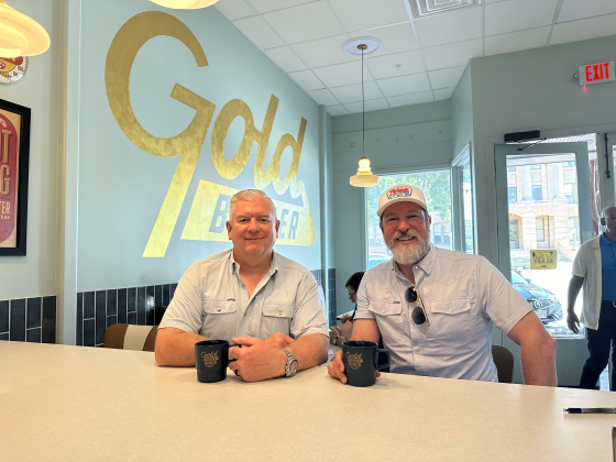 Tommy McCormick (left) and Cody Hirt sit at the counter in Gold Burger Diner, which will open on the Square later this month.