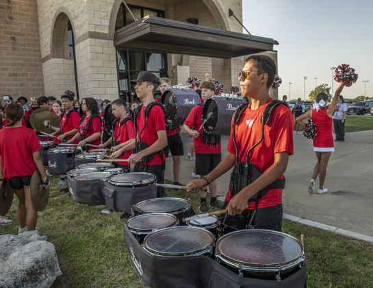 Noah Valadez, 16, a member of the East View High School marching band, joined other band members and cheerleaders from East View and Georgetown High outside the East View High School gym, welcoming attendees  during the convocation for Georgetown Independent School District staff on Tuesday, August 6.