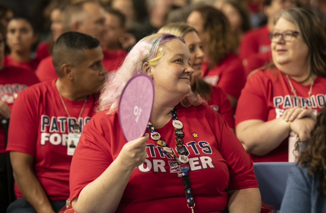 East View High School yearbook instructor Holly Nichols brought a hand fan to keep the air moving around her during the convocation for Georgetown Independent School District staff on Tuesday, August 6, 2024.   Georgetown public schools open on August 15.  Photo by Andy Sharp.