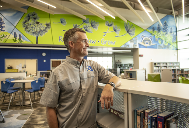 Benold Middle School principal Brandon Jayroe is pictured in the school library  on Monday, August 5, 2024.  The mural in the background was created by Georgetown artist Sarah Blankenship.  The school, along with San Gabriel Elementary School,  are two schools that open their doors to students on August 15.  Photo by Andy Sharp