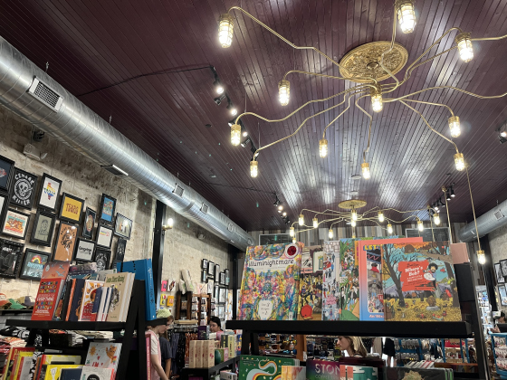 The gold light fixtures used to have colored bulbs to provide moody lighting for the live music performances. Now, the gold light fixtures have normal light bulbs, providing lighting that is more appropriate for a retail space. 