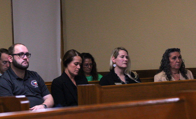 All four Wilco Justices of the Peace sit in the Commissioner Courtroom and listen to how the commissioners plan to incorporate death investigators into the budget. Photo by Nalani Nuylan.