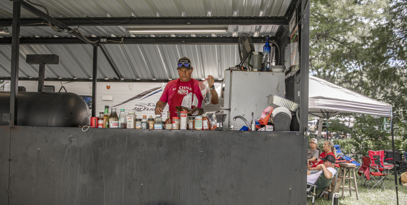 Buddy Michna, with the Michna Tribe team, prepares entries  at  the 45th Taylor International BBQ Cook-Off on Saturday, August 17, 2024.  The Michna family has taken part in every cookoff here since 1979.  Held at Murphy Park, the event, attracting entrants from all over Texas, continued through Saturday.    Photo by Andy Sharp.