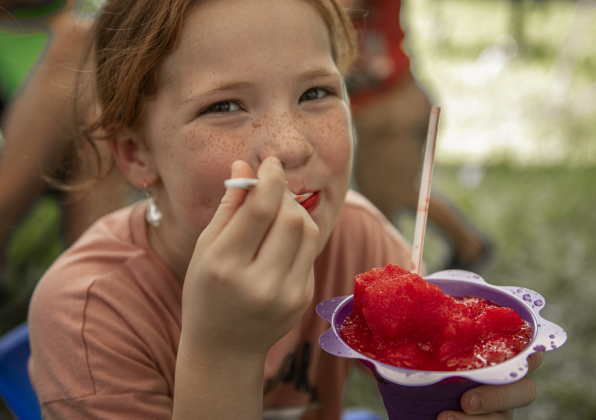 8-year-old Harper Mensik enjoyed an icy snow cone on a hot afternoon  at  the 45th Taylor International BBQ Cook-Off on Saturday, August 17, 2024.  Held at Murphy Park, the event, attracting entrants from all over Texas, continued through Saturday.    Photo by Andy Sharp.