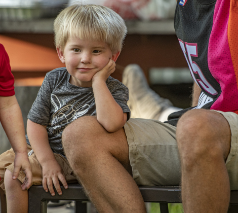 3-year-old Ryder Copeland enjoys time with his family during  the 45th Taylor International BBQ Cook-Off on Friday, August 16, 2024.  Held at Murphy Park, the event, attracting entrants from all over Texas, continued through Saturday.    Photo by Andy Sharp.