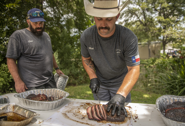 Drew Clinkscales, left, and Matt Bishop, with the  M & D Texas BBQ team, prepare their three briskets for judging at  the 45th Taylor International BBQ Cook-Off on Saturday, August 17, 2024.  Held at Murphy Park, the event, attracting entrants from all over Texas, continued through Saturday.    Photo by Andy Sharp. 