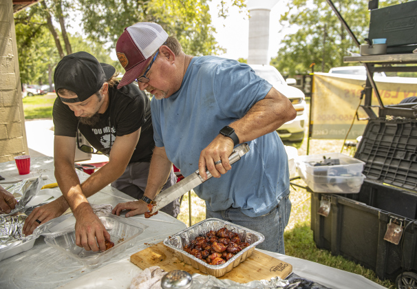 Eric Kaderka, left, and Bubba Cepak, with the Smoke This team, prepare their San Gabriel Shrimp Balls  for judging  in the Cook's Choice category at  the 45th Taylor International BBQ Cook-Off on Saturday, August 17, 2024.  Held at Murphy Park, the event, attracting entrants from all over Texas, continued through Saturday.    Photo by Andy Sharp.