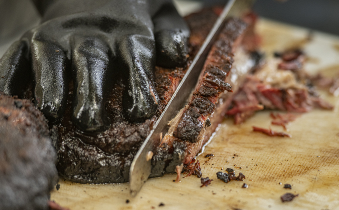 Thomas "Tomcat" Wilson, with the Smoke That team, prepares briskets for judging at  the 45th Taylor International BBQ Cook-Off on Saturday, August 17, 2024.  Held at Murphy Park, the event, attracting entrants from all over Texas, continued through Saturday.    Photo by Andy Sharp.
