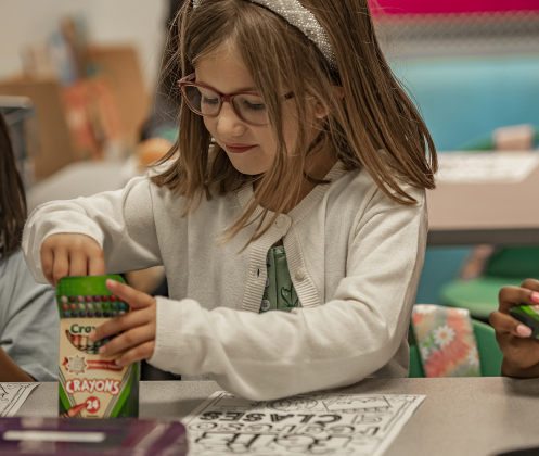 6-year-old Charlotte Hejny settles into her first grade classroom at Cooper Elementary on Thursday morning, August 15, 2024,  the first day of school.   Cooper Elementary has 572 students enrolled this year.    Photo by Andy Sharp.
