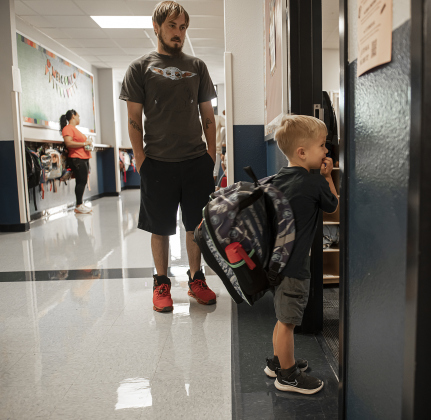 4-year-old Cooper Lockwood, joined at left by his father Braxton Lockwood,  totes a large backpack as he prepares to go into his Pre-K classroom at Cooper Elementary on Thursday morning, August 15, 2024,  the first day of school.   Cooper Elementary has 572 students enrolled this year.    Photo by Andy Sharp.