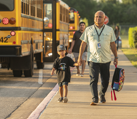 Rigo Garcia holds hands with his son Roman, 4, as Roman heads for his first day of Pre-K class  at Cooper Elementary on Thursday morning, August 15, 2024,  the first day of school.   Cooper Elementary has 572 students enrolled this year.    Photo by Andy Sharp. 