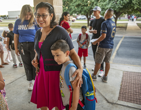 Mom Alicia Willingham waits with her first-grader son Kaden for the doors to open  at Cooper Elementary School  on Thursday morning, August 15, 2024,  the first day of school.  Cooper Elementary has 572 students enrolled this year.    Photo by Andy Sharp.