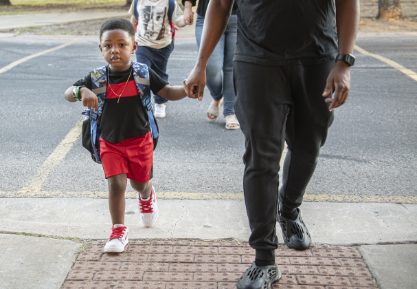 4-year-old Cayman Wade is accompanied by his father Terrent Polk as he's off for his first day of Pre-K at Cooper Elementary on Thursday morning, August 15, 2024,  the first day of school.  Cooper Elementary has 572 students enrolled this year.    Photo by Andy Sharp.