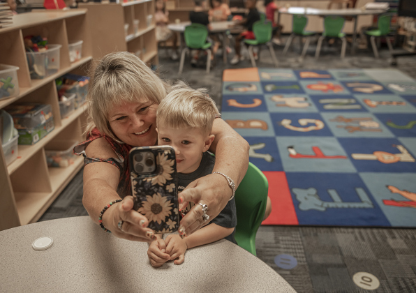 Nina Curry takes a photo with her grandson Cooper Lockwood, 4, in his Pre-K classroom at Cooper Elementary on Thursday morning, August 15, 2024,  the first day of school.   Cooper Elementary has 572 students enrolled this year.    Photo by Andy Sharp.