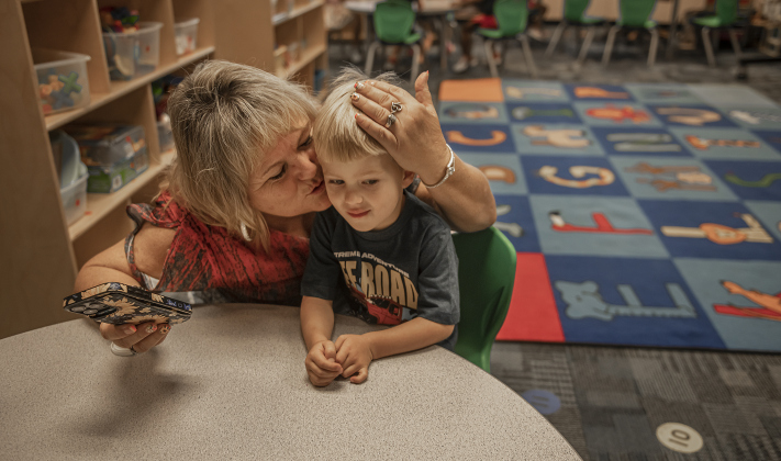 Nina Curry gives her grandson Cooper Lockwood, 4, a kiss before leaving him for the day in his Pre-K classroom  at Cooper Elementary on Thursday morning, August 15, 2024,  the first day of school.  Cooper Elementary has 572 students enrolled this year.    Photo by Andy Sharp.