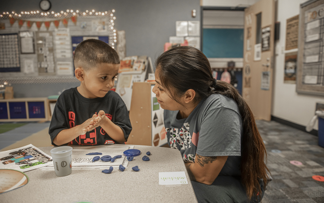 5-year-old Jedidiah Barrera spends time  with his mom Jackie Barrera before mom leaves him with his kindergarten classmates at Cooper Elementary on Thursday morning, August 15, 2024,  the first day of school.   Cooper Elementary has 572 students enrolled this year.    Photo by Andy Sharp.