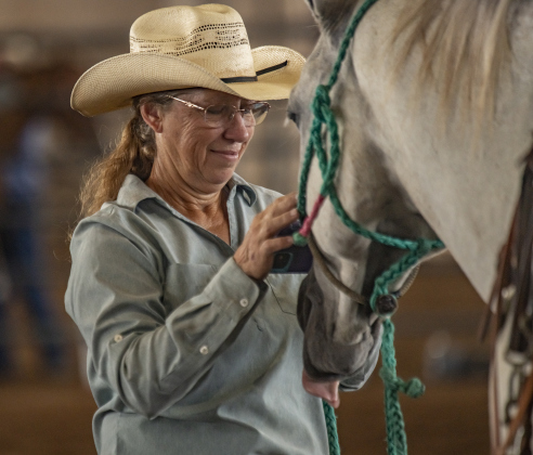 Gail Broussard spends time with her horse named Zach after they competed in Ladies Breakaway Roping.