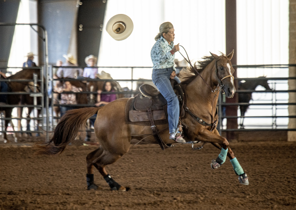 ane Armstrong, 73, of Bryan, Texas loses her hat during  the Barrel Racing  competition.