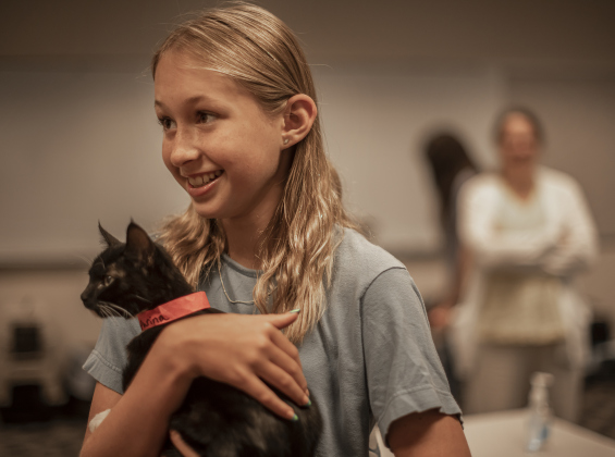 13-year-old Sloane Den Beste cuddles the kitten her family adopted during the event.