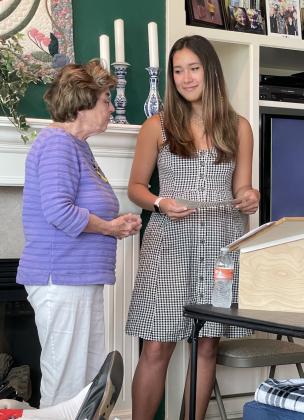 Amelia Tesering accepting scholarship.