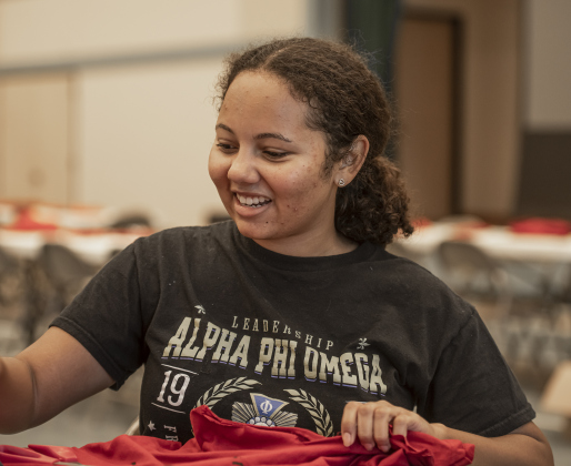 Southwestern University student Bri Westmoreland joins other members of her Alpha Phi Omega Sorority as they create bags out of donated t-shirts during a 9/11 National Day of Service event held at Georgetown's Christ Lutheran Church on Saturday, September 7, 2024.  Volunteers from churches, synagogues and mosques, including some who just wanted to contribute helped repurpose t-shirts to be used as bags at The Caring Place, Helping Hands of Georgetown and the Carver Center for Families.   Photo by Andy Sharp