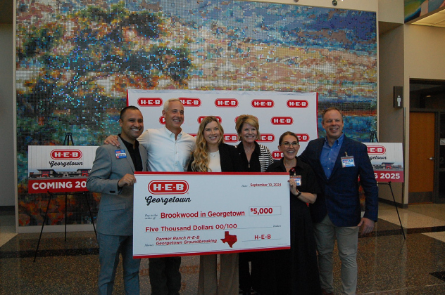 Representatives from H-E-B, Brookwood in Georgetown and Mayor Josh Schroeder pose with a donation for $5,000.