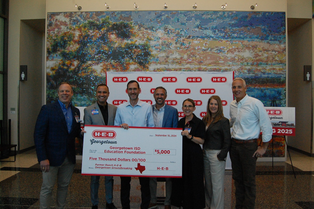 Representatives from H-E-B, Georgetown ISD Education Foundation and Mayor Josh Schroeder pose with a donation for $5,000.