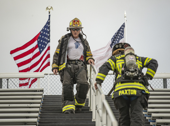 Georgetown Fire Department Battalion Chief Carl Boatright, left, and firefighter Russell Paxton, right, take part in the Memorial Stair Climb at Birkelbach Field on Wednesday, September 11, 2024, the 23rd anniversary of the attacks on United States soil in New York, Pennsylvania and Washington, D.C.  Boatright is one of the founders of this now annual event.   The Memorial Stair Climb began here in 2011.  Photo by Andy Sharp.