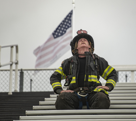 Georgetown Fire Department firefighter Russell Paxton shows the effect of a long time of the steps as he nears the completion of  the Memorial Stair Climb at Birkelbach Field on Wednesday, September 11, 2024, the 23rd anniversary of the attacks on United States soil in New York, Pennsylvania and Washington, D.C.  The Memorial Stair Climb began here in 2011.  Photo by Andy Sharp.