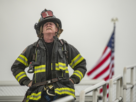 Georgetown Fire Department firefighter Russell Paxton can't hide his weariness near the completion of his participation in the Memorial Stair Climb at Birkelbach Field on Wednesday, September 11, 2024, the 23rd anniversary of the attacks on United States soil in New York, Pennsylvania and Washington, D.C. The Memorial Stair Climb began here in 2011.  Photo by Andy Sharp. 
